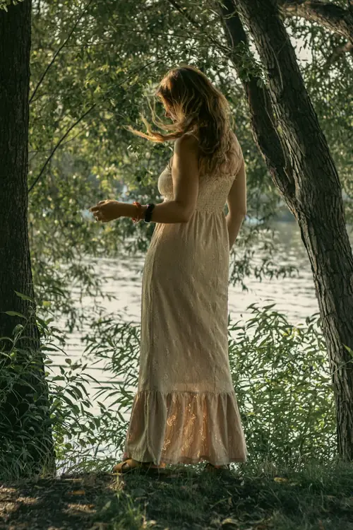 Rezi turning, her dress in motion by the river